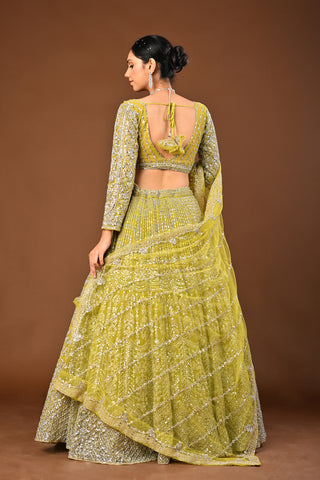 Designer Lemon Green Soft Net Lehenga adorned with Mirror