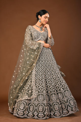 Designer Mehandi green Soft Net Lehenga adorned with Kundan and Stone