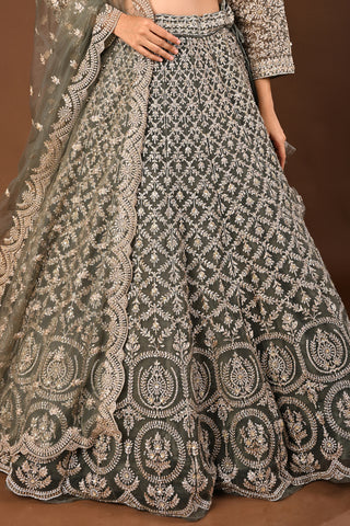Designer Mehandi green Soft Net Lehenga adorned with Kundan and Stone
