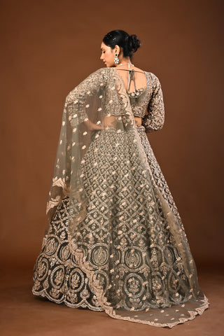 Designer Mehandi green Soft Net Lehenga adorned with Kundan and Stone